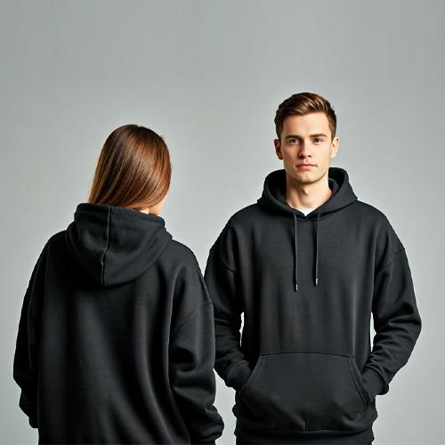 A model showcases a navy hoodie with a gray pocket and a gray t-shirt. Close-ups of the fabric texture are included.
